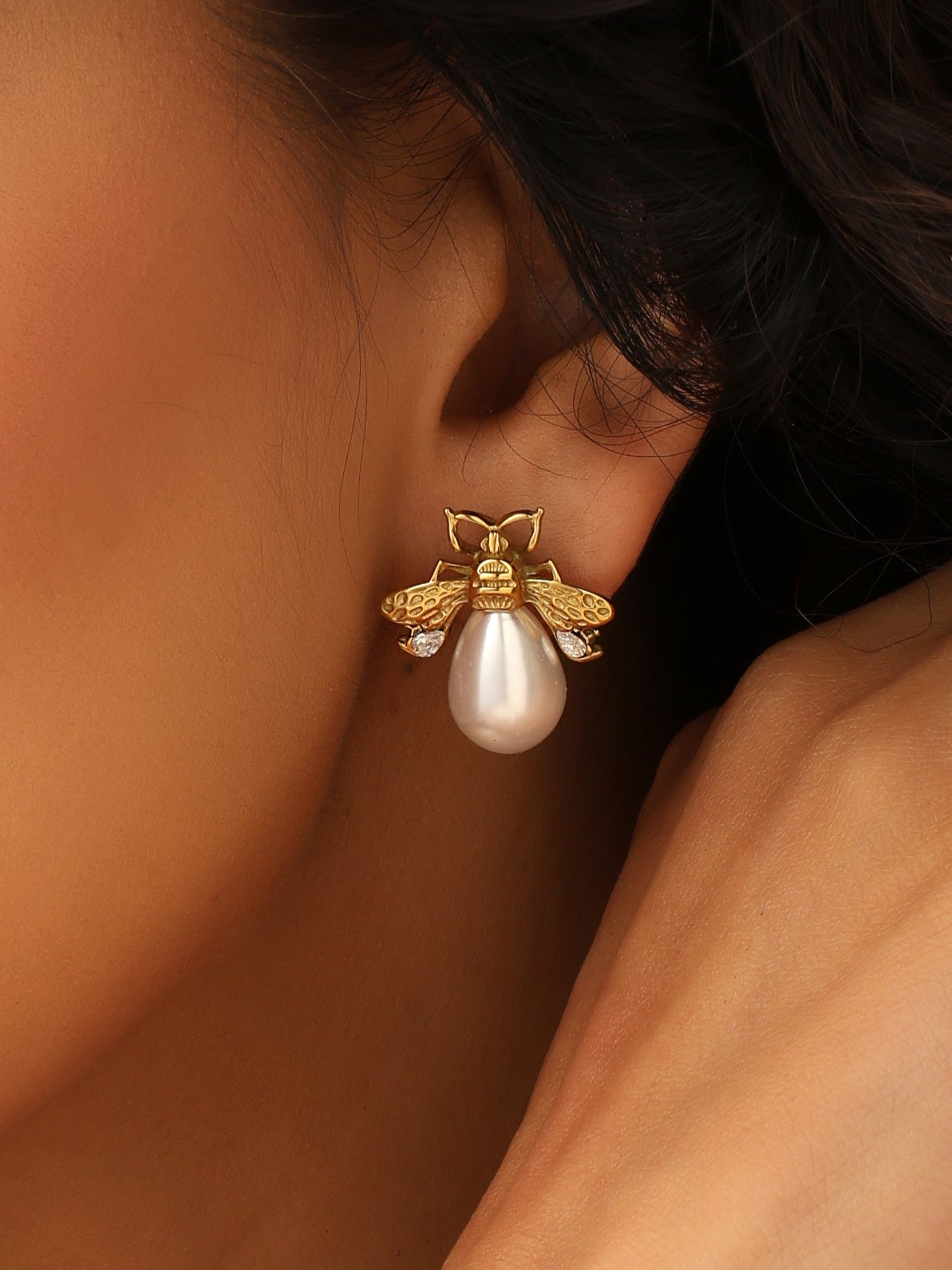 Close-up of a pearl earring worn by a person